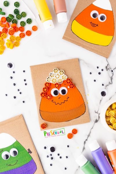 Once your candy corn has dried, it’s time to add some creative flair by gluing on the pasta! Students have two fun options: they can apply a bit of glue directly onto each wagon wheel pasta piece before pressing it onto their painted candy corn, or you can set up a dipping station with glue in a bowl or on parchment paper. This way, they can dip the pasta and then attach it to their project. 